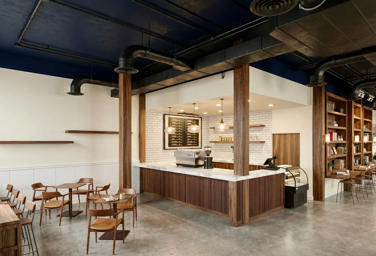 The espresso bar at Bayit Brew with walnut counter, marble top, and copper pendants.